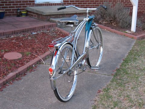 1994 Ford Bronco - A vintage bicycle with chrome accents and a teal fender is parked on a sidewalk.