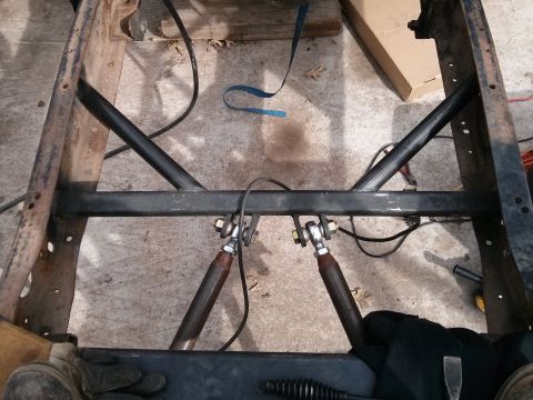 1986 Ford Bronco - Close-up of a vehicle's frame and suspension system, showing custom bracing and shocks.