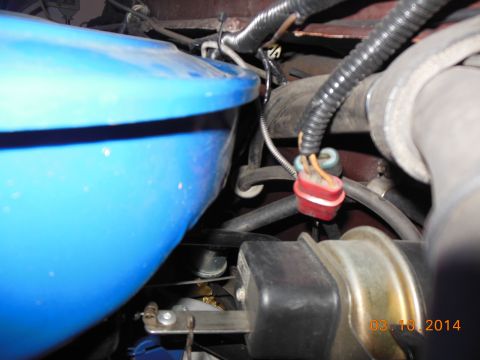 1979 Ford F-150 - Close-up view of engine bay components, including a blue air cleaner housing and electrical connectors.