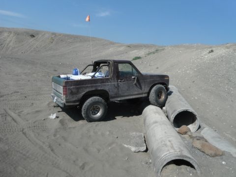 1980 Ford Bronco - This 1980 Ford Bronco is shown navigating a challenging off-road course with concrete pipes.