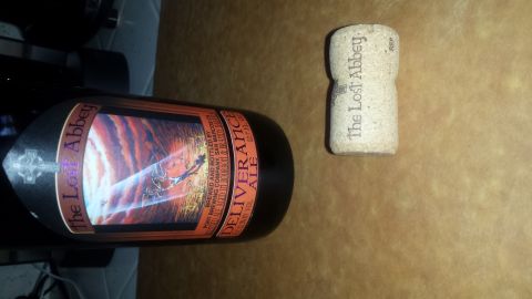 1996 Ford Bronco - A beer bottle and its cork are shown on a brown surface.
