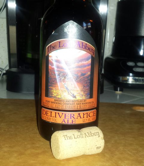 1996 Ford Bronco - A bottle of Deliverance Ale sits on a wooden surface with its cork nearby.