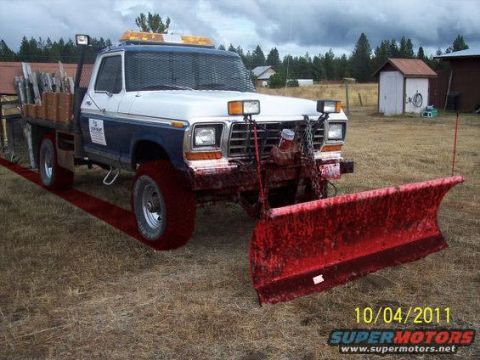 1994 Ford Bronco - This truck is equipped with a snow plow and a flatbed, ready for winter work.