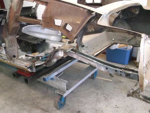 1967 Ford Mustang - Body shell of a 1967 Ford Mustang undergoing restoration work on a wheeled dolly.