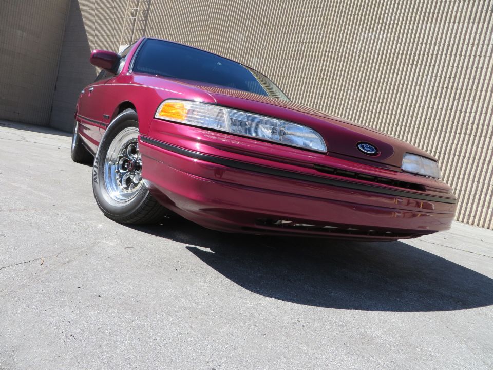 Maroon 1992 Ford Crown Victoria with Weld Magnum III wheels parked on asphalt