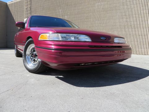 1992 Ford Crown Victoria - A maroon 1992 Ford Crown Victoria is shown from the front 3/4 angle, Weld Magnum III wheels.