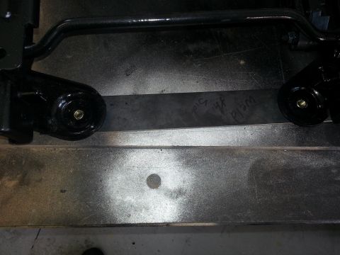 1994 Ford Bronco - Close-up of a black seat bracket, showing weld marks and mounting points.