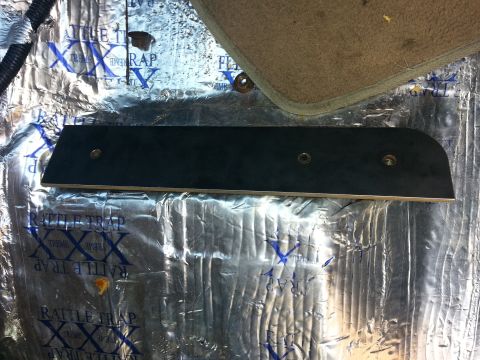 1994 Ford Bronco - Sound deadening material is applied to the floor of a vehicle, with a black trim piece installed over it.
