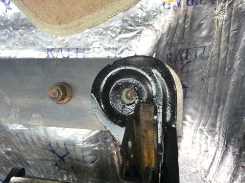 1994 Ford Bronco - Close-up view of a seat mounting bracket, showing insulation and a bolt. The registry information may be incorrect.