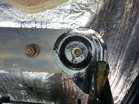 1994 Ford Bronco - Seat mounting bracket with insulation visible in the background. No vehicle year identified.