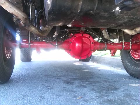 1992 Ford Bronco - The underside of a vehicle is shown, focusing on the rear differential and suspension system.