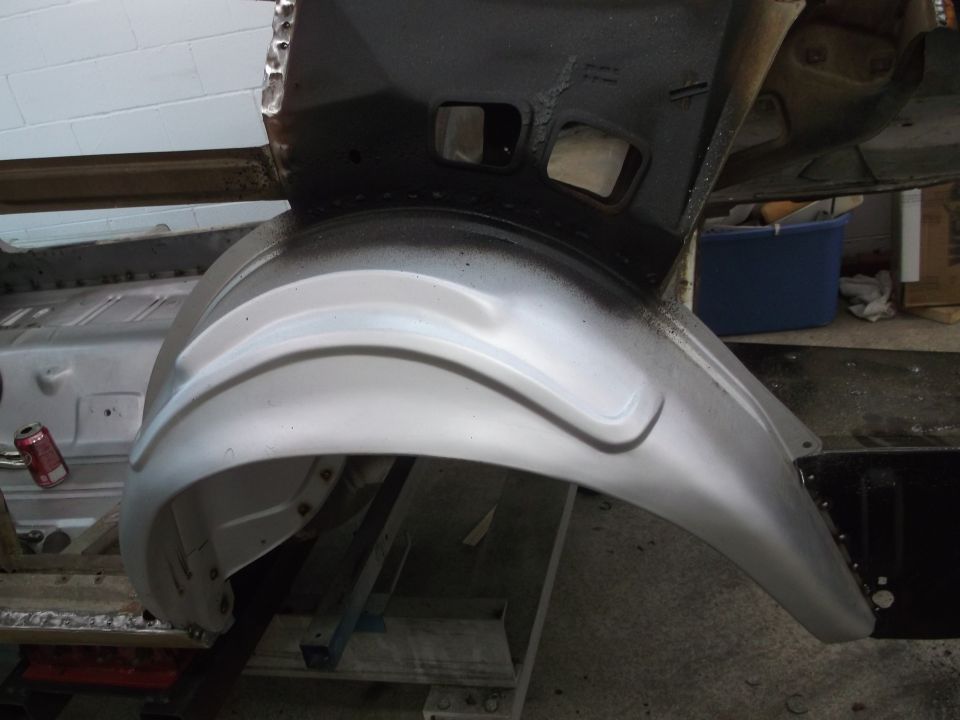 Silver rear wheel well and chassis components, partially painted