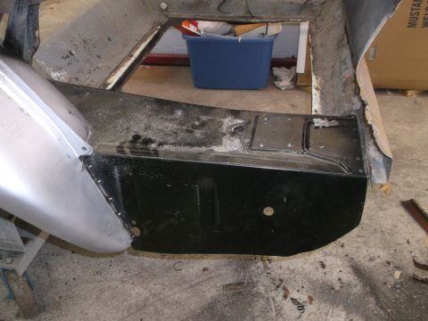 1967 Ford Mustang - Repair work on a car's floor pan, with visible metal components and some debris.
