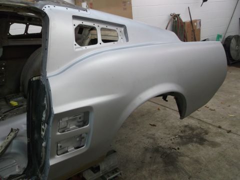 1967 Ford Mustang - This silver car body panel shows the rear quarter and door frame, indicating it is part of a vehicle undergoing restoration.