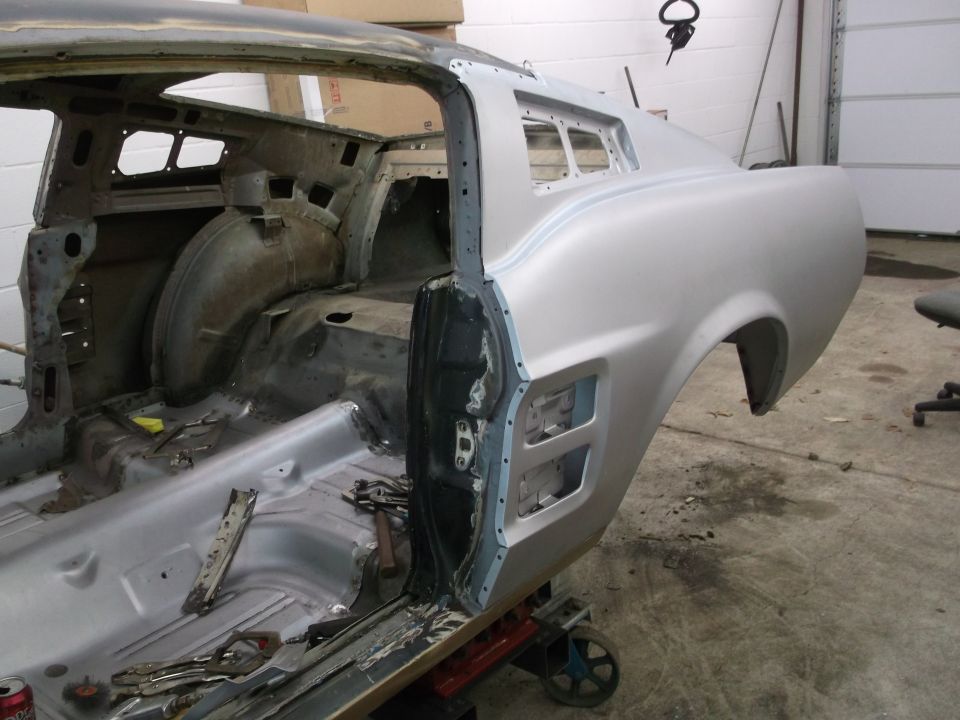 Silver 1967 Ford Mustang body, side view, undergoing restoration