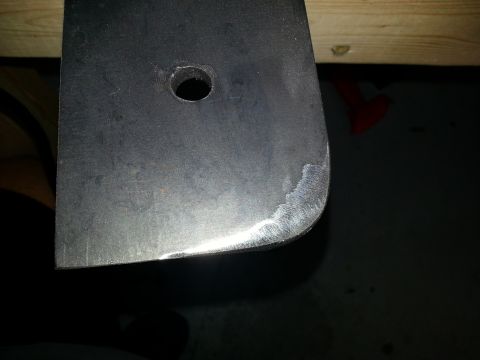 1994 Ford Bronco - A metal bracket with a hole and rounded edge is shown, with "SUPERMOTORS" visible at the bottom.