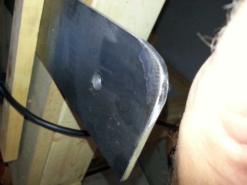 1994 Ford Bronco - A close-up view of a metal bracket, possibly a vehicle part, secured to wooden supports.