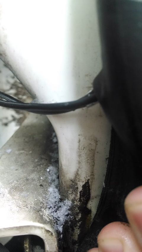 1995 Ford Bronco - Close-up view of a white vehicle component, showing black trim and wiring, with a Supermotors.net logo at the bottom.