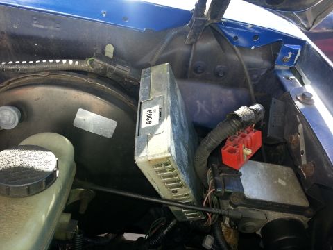 1994 Ford Bronco - Close-up view of the engine bay, showing the brake booster and an engine control module.