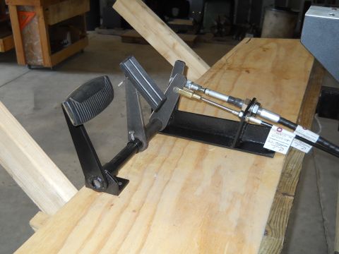 1992 Ford Bronco - Close-up view of brake and accelerator pedals connected to control cables.