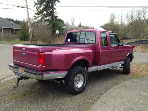 1992 Ford F-150 - This 1992 Ford F-150 pickup truck is shown from the rear three-quarter angle.