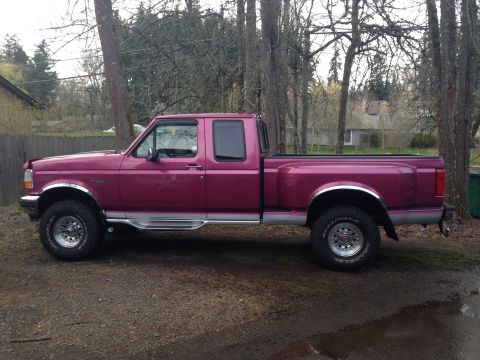 1992 Ford F-150 - Side profile of a purple 1992 Ford F-150 pickup truck parked outdoors.