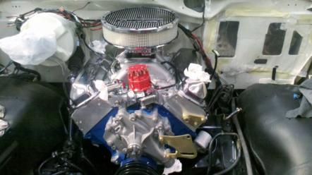1982 Ford Bronco - Engine bay view of a V8 engine with chrome accents and a red distributor cap.