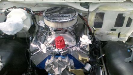 1982 Ford Bronco - Engine bay view of a V8 motor with chrome air cleaner and red distributor cap.