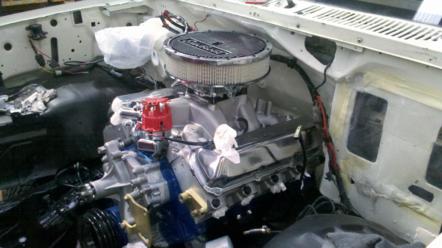 1982 Ford Bronco - The engine bay of a vehicle is shown with a V8 engine, air cleaner, and distributor cap installed.