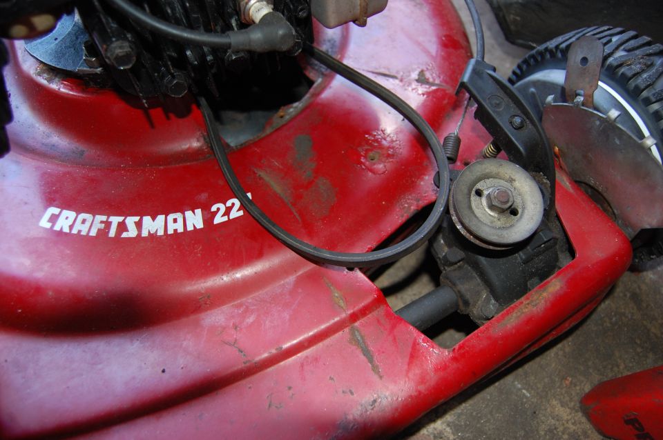 Red Craftsman 22" lawnmower deck with visible engine components and drive belt