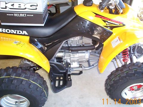 1978 Ford Bronco - A yellow Honda ATV is shown from the side, with its engine and suspension clearly visible.