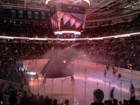 1968 Ford Bronco - A large shark fin prop is lowered over the ice rink at the SAP Center during a hockey game.