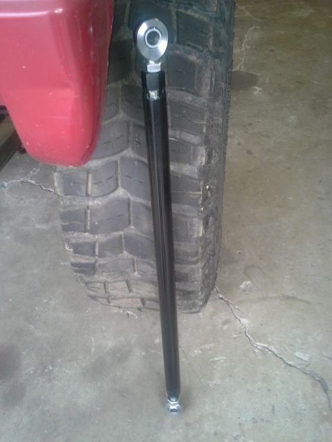1968 Ford Bronco - A close-up view of a vehicle's suspension component, likely a tie rod end, near the tire.