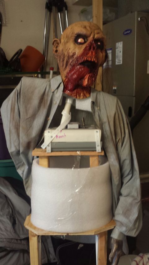 1989 Ford Bronco - A zombie prop is displayed indoors, with visible text on a component near its torso.