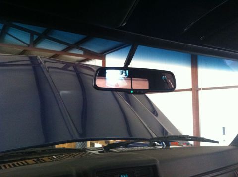1982 Ford Bronco - Interior view of a blue vehicle, focusing on the rearview mirror with a digital display.