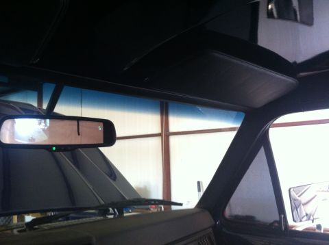 1982 Ford Bronco - View from inside a vehicle, focusing on the rearview mirror and the upper portion of the windshield.
