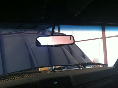 1982 Ford Bronco - The digital clock on the dashboard reads 9:44, and the rearview mirror shows a reflection of the interior.