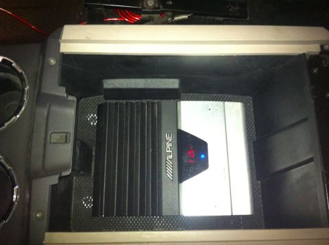 1982 Ford Bronco - Alpine amplifier with a digital display showing '1.15' is visible inside a vehicle's console.