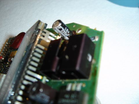 1996 Ford Bronco - A close-up of electronic components on a circuit board, with visible capacitors and black integrated circuits.