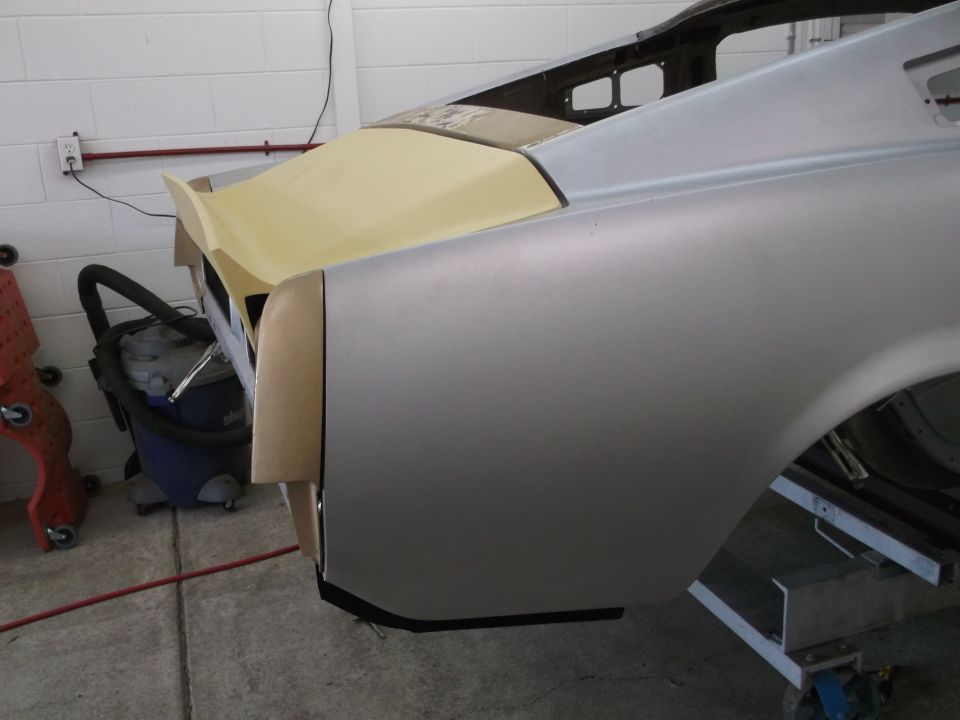 Unfinished car body, silver, rear quarter panel and trunk area, yellow primer on spoiler