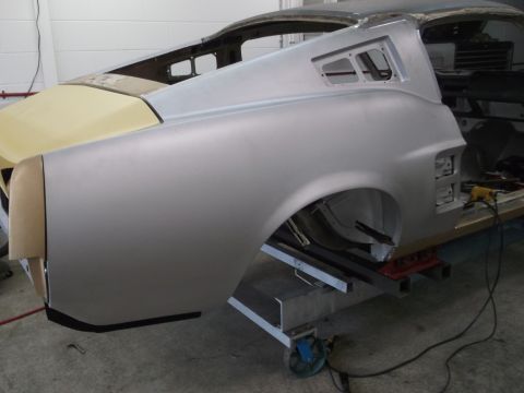 1967 Ford Mustang - The rear quarter panel and trunk area of a 1967 Ford Mustang, shown in primer during restoration.