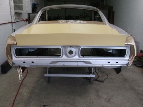 1967 Ford Mustang - Rear view of a 1967 Ford Mustang body shell in a workshop, prepped for paint.
