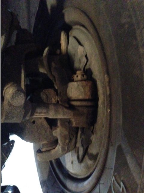 1995 Ford Bronco - This image shows a close-up view of a vehicle's suspension system, specifically the tie rod end and ball joint.
