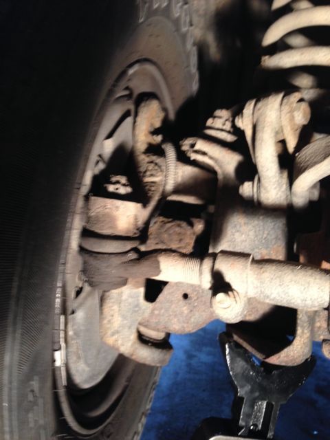1995 Ford Bronco - Close-up view of the front suspension tie rod end on a 1995 Ford Bronco.