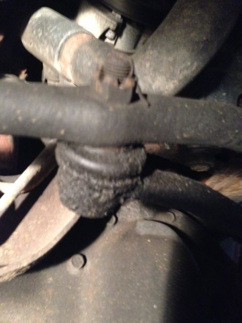 1995 Ford Bronco - Worn ball joint in steering linkage, likely needs replacement.