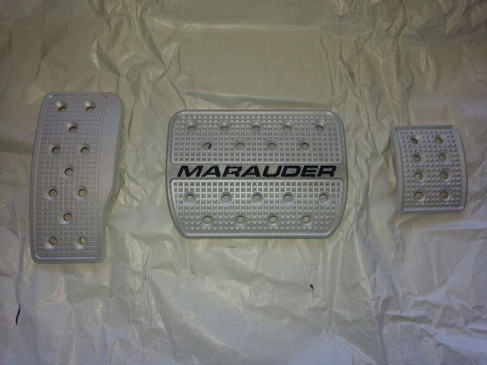 Set of three silver pedal covers, one with MARAUDER text