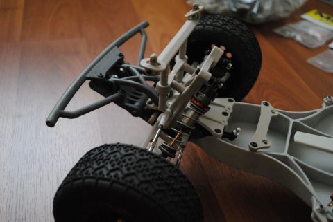 1986 Ford Bronco - Chassis of a remote control car, showing suspension and wheels.