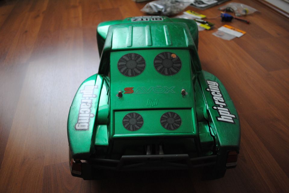 Green remote control car body with 'hpi-racing' decals and four fan details