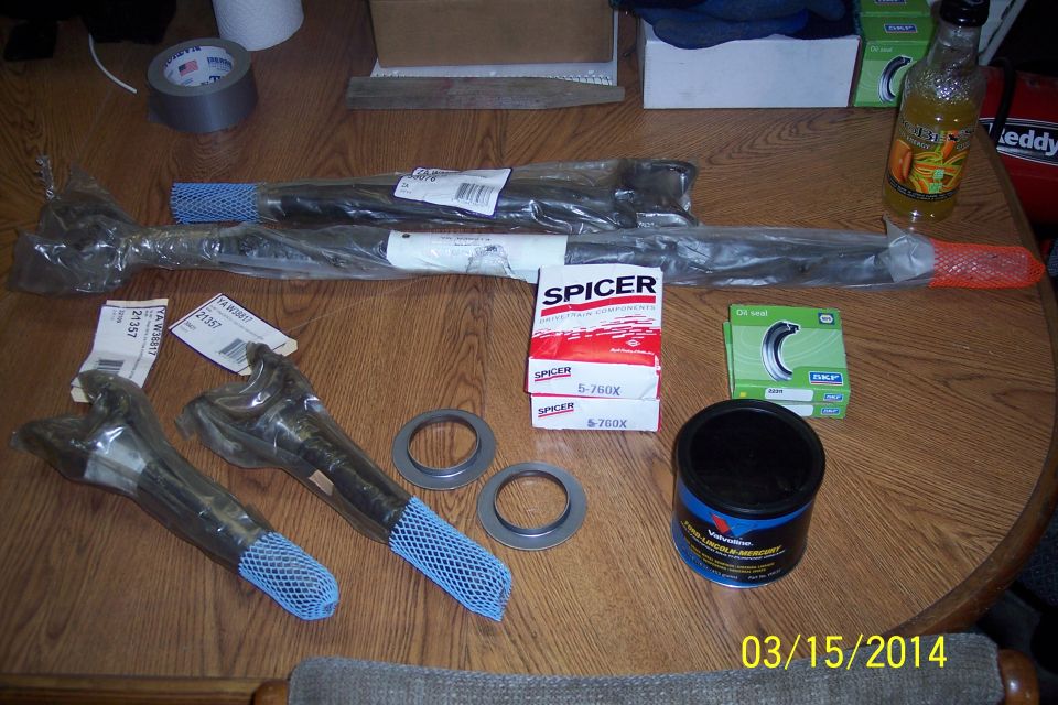 Spicer front axle parts and grease on a wooden table