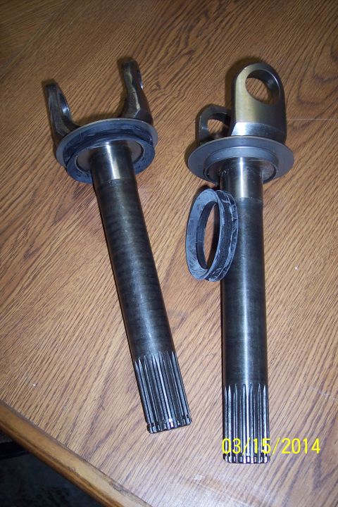 1973 Ford F-250 - Two metal shafts, likely for a vehicle's drivetrain, are shown on a wooden surface. A date stamp indicates 08/15/2014.